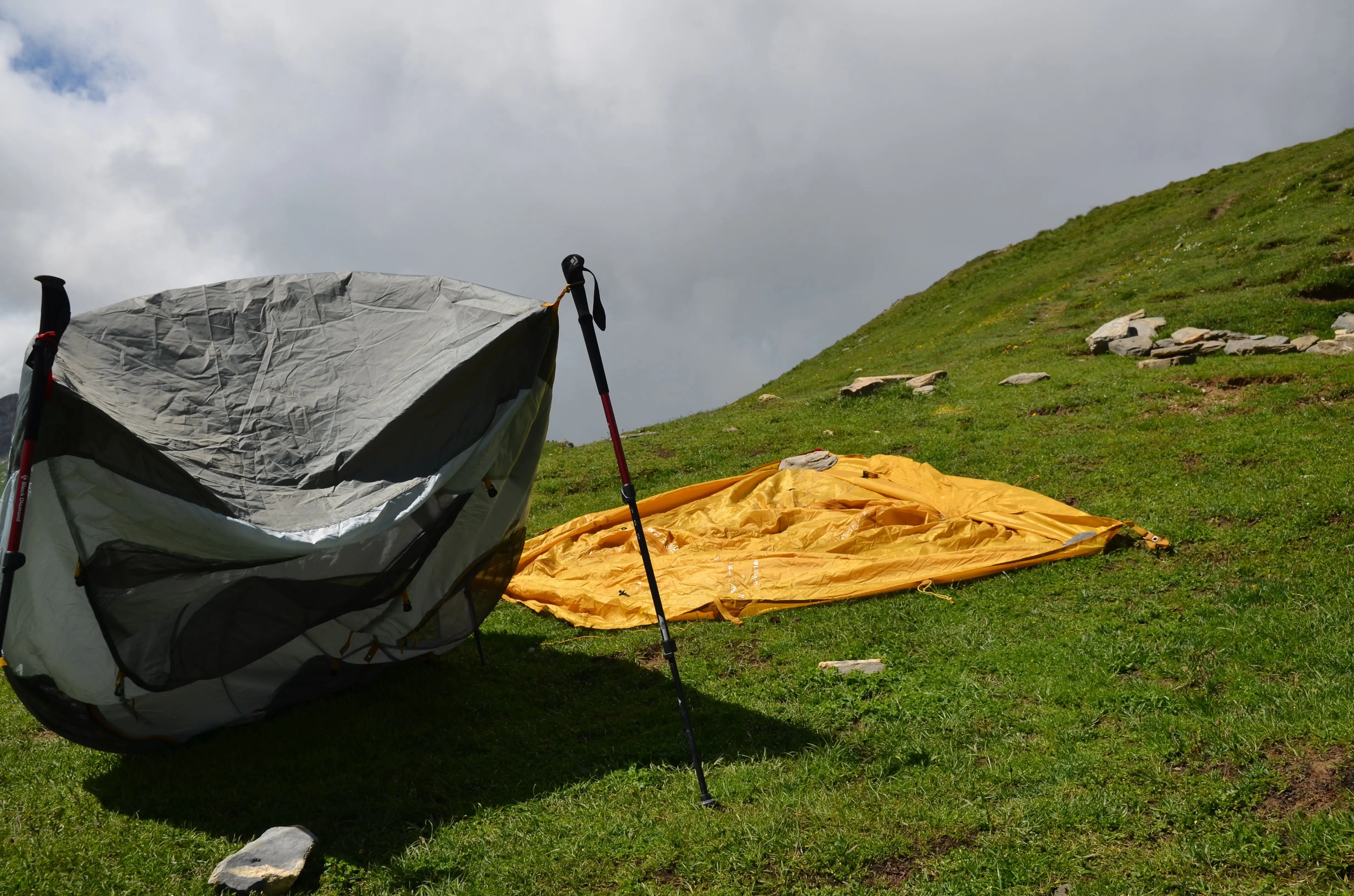 Camping gear and tents drying in the sun at a mountain stop Camping gear and tents drying in the sun at a mountain stop